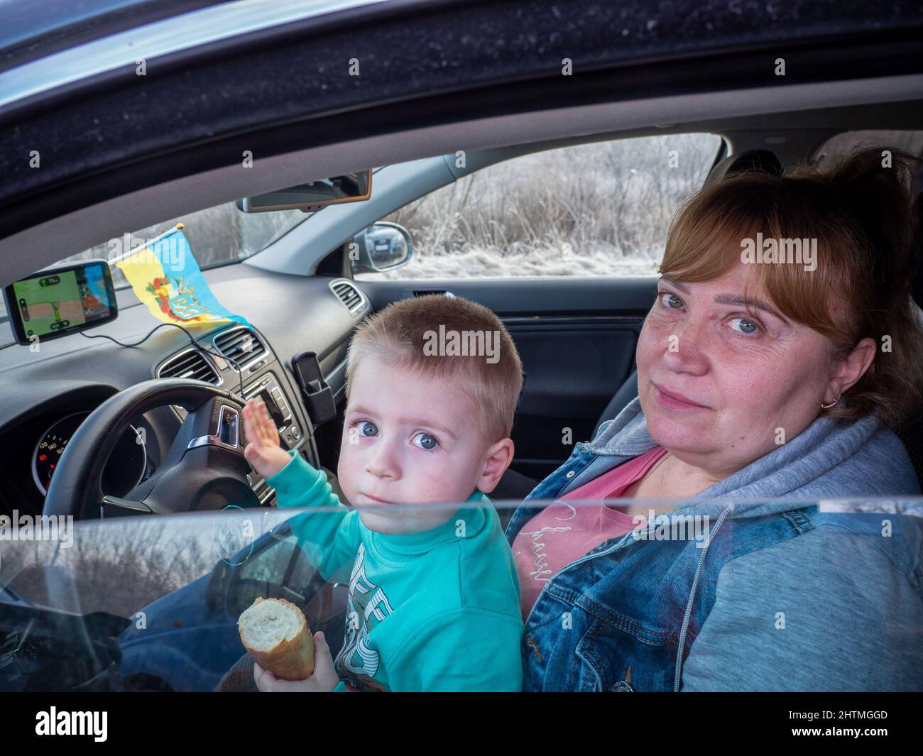 Yavoriv, Ukraine. 26th Feb, 2022. Refugees seen waiting in a vehicle as they wait to cross the border into Poland.At dawn of 24 February 2022, Russia launched a full-scale invasion to Ukraine. Civilian homes and hospitals have been destroyed by the Russian military action which caused many people to become homeless. (Credit Image: © Jana Cavojska/SOPA Images via ZUMA Press Wire) Stock Photo