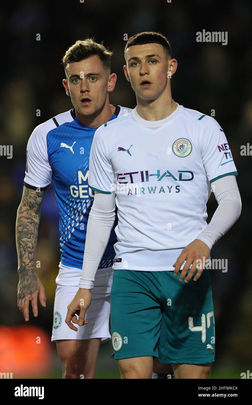 PETERBOROUGH, UK. MAR 1ST. Phil Foden of Manchester City and Sammie Szmodics of Peterborough United look on during the FA Cup FIFTH ROUND TIE between Peterborough United and Manchester City at Weston Homes Stadium, Peterborough on Tuesday 1st March 2022. (Credit: James Holyoak | MI News) Credit: MI News & Sport /Alamy Live News Stock Photo
