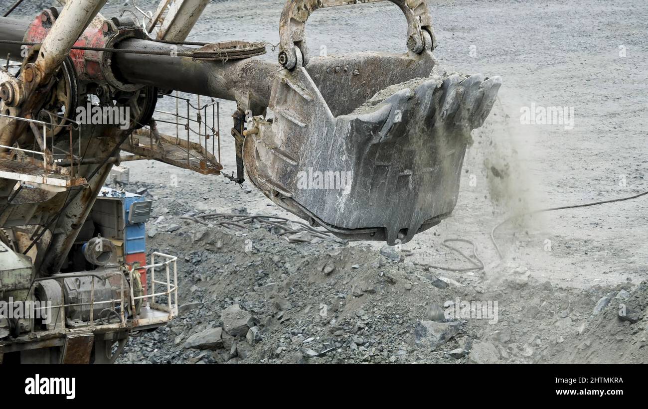 Scoop Of Excavator Is Digging Hole. Excavator Digs Pit In Ground For 