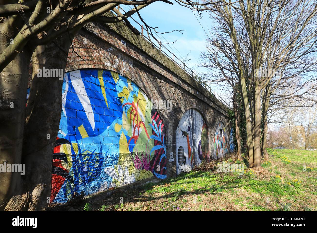 Ackroyd Drive Green Link, east London's only chalk meadow, with spring flowers, street murals on the railway arches and part of Tower Hamlets Cemetery Stock Photo