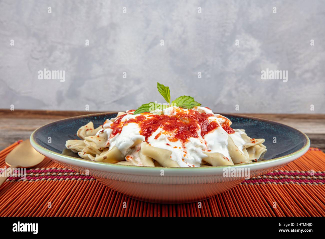 Plates of traditional Turkish food. Turkish Ravioli (Mantı) with