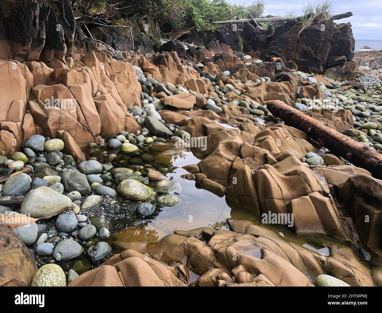 water on the beach and some beautiful stones in it Stock Photo - Alamy