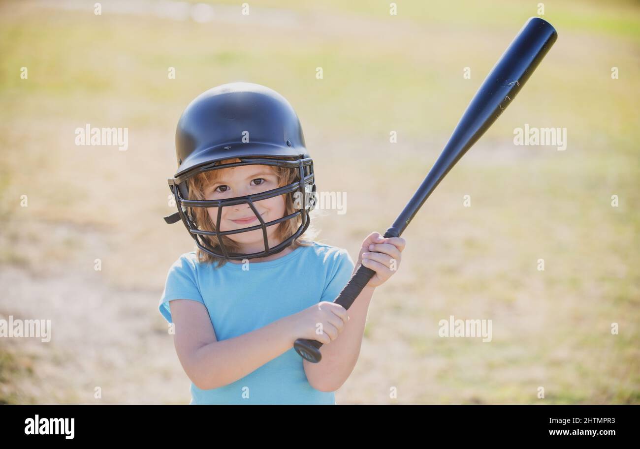 Little child baseball player focused ready to bat. Kid holding a