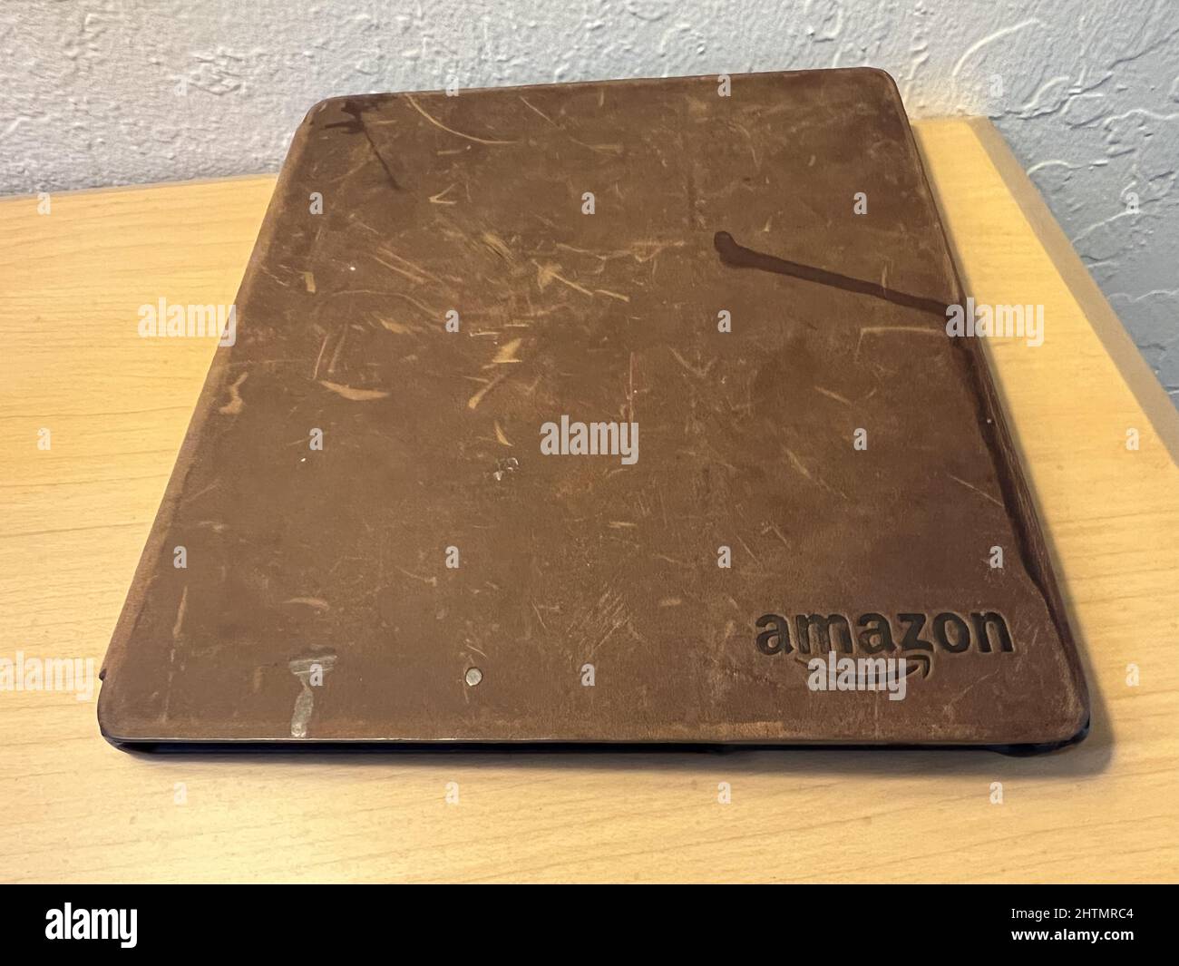 Amazon Kindle Oasis with leather case showing scratches and damage on a nightstand, Lafayette, California, January 20, 2022. Photo courtesy Tech Trends. Stock Photo