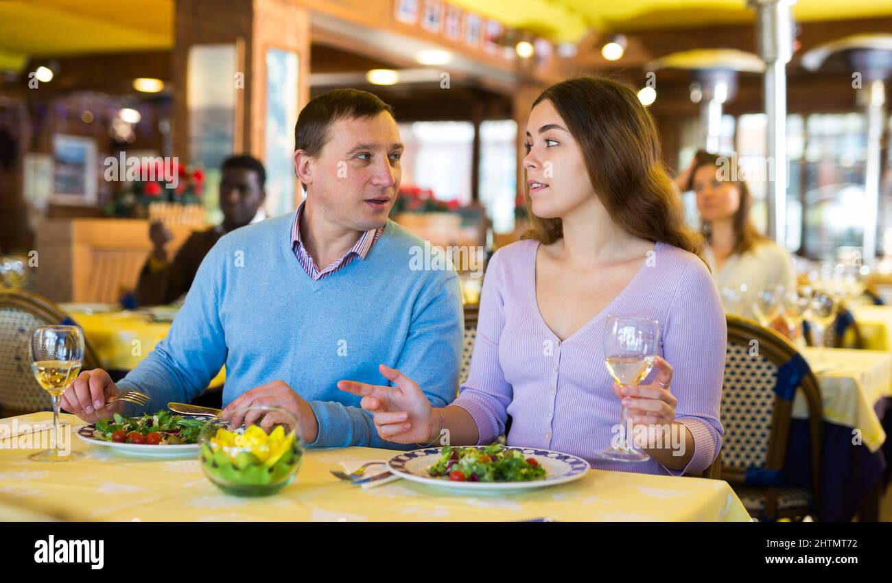 Couple chatting while having dinner in restaurant Stock Photo - Alamy