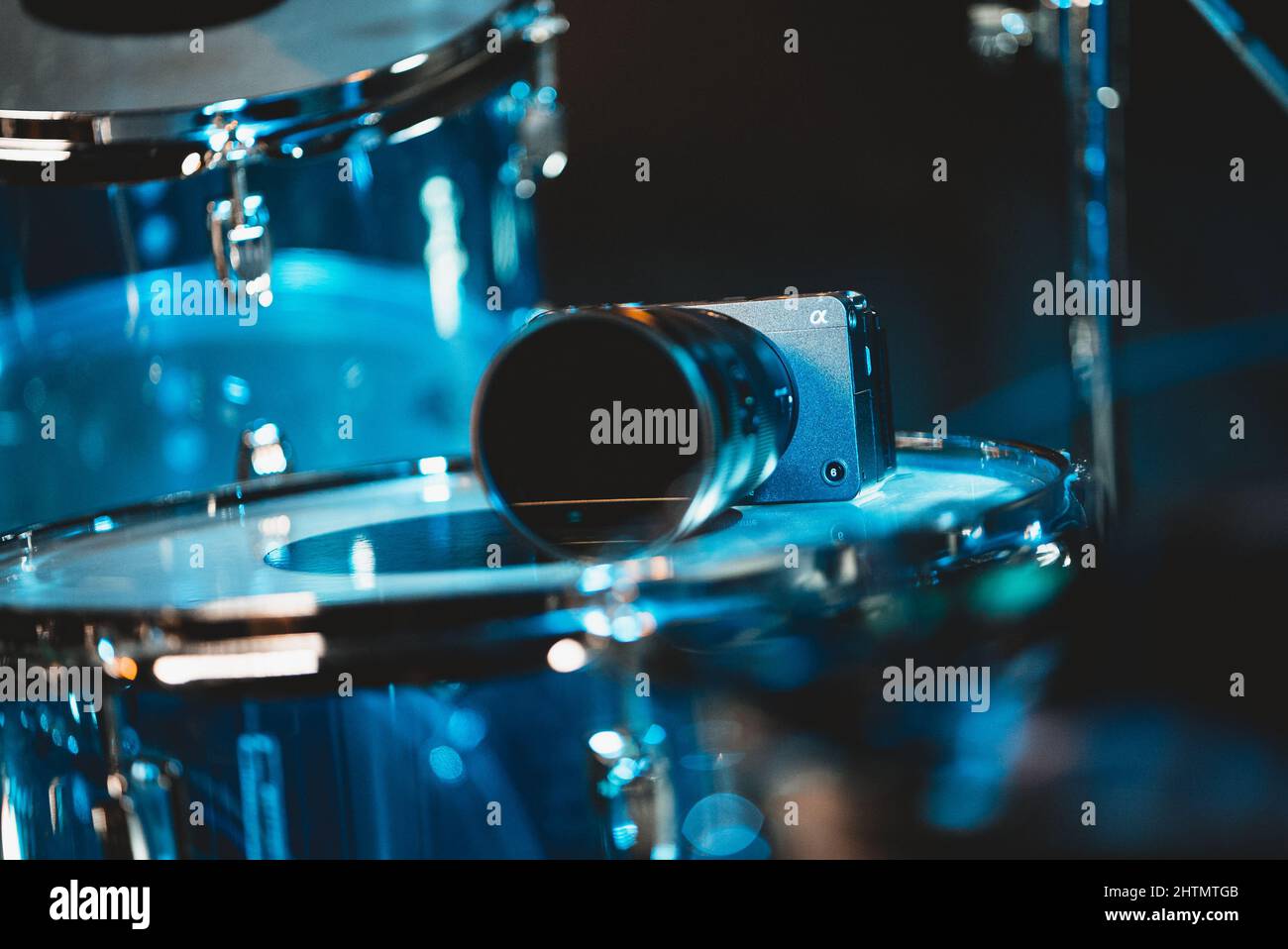 Selective focus shot of illuminated drum instruments on a stage at ...