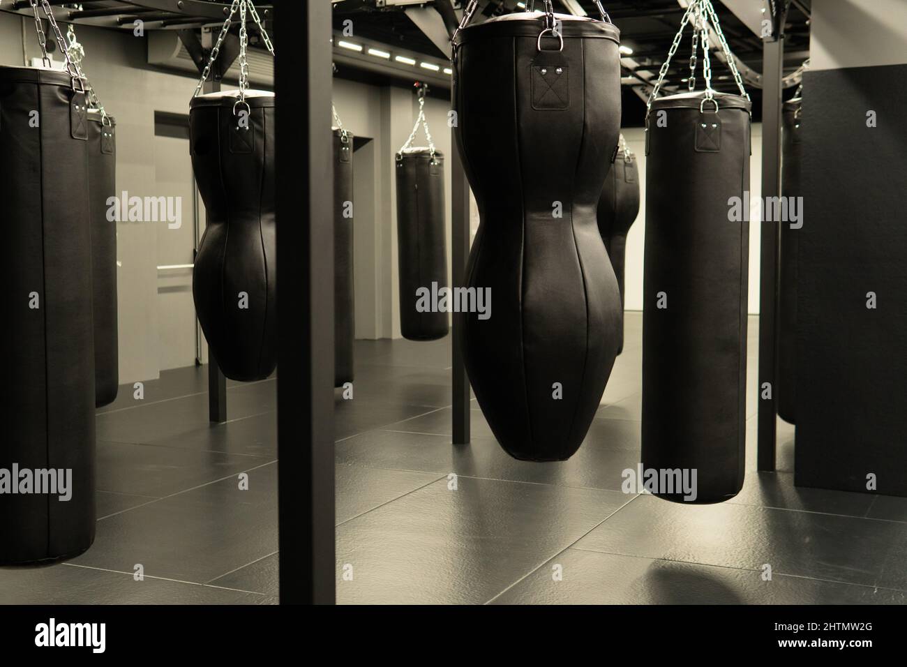 bag punching boxing background indoors, from power kick from punch for