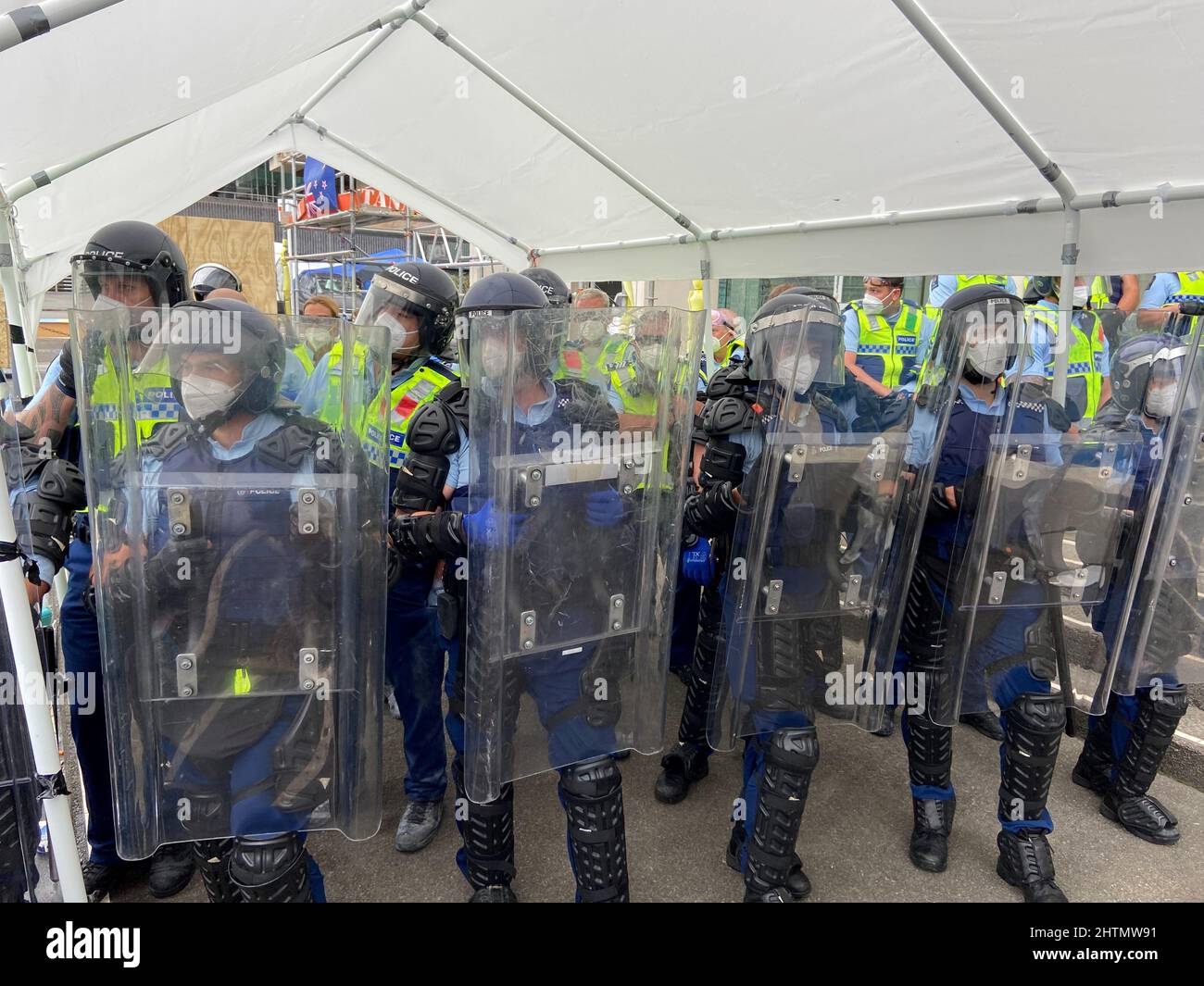 Police stand guard as protesters against the coronavirus disease (COVID-19) restrictions and vaccine mandates gather in front of the parliament in Wellington, New Zealand, March 2, 2022,. REUTERS/Praveen Menon Stock Photo
