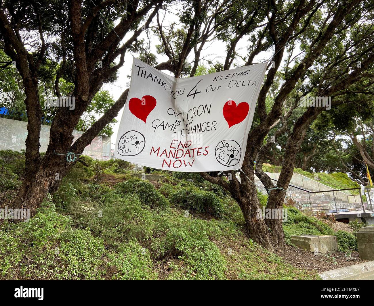 A banner is seen as protesters against the coronavirus disease (COVID-19) restrictions and vaccine mandates gather in front of the parliament in Wellington, New Zealand, March 2, 2022,. REUTERS/Praveen Menon Stock Photo