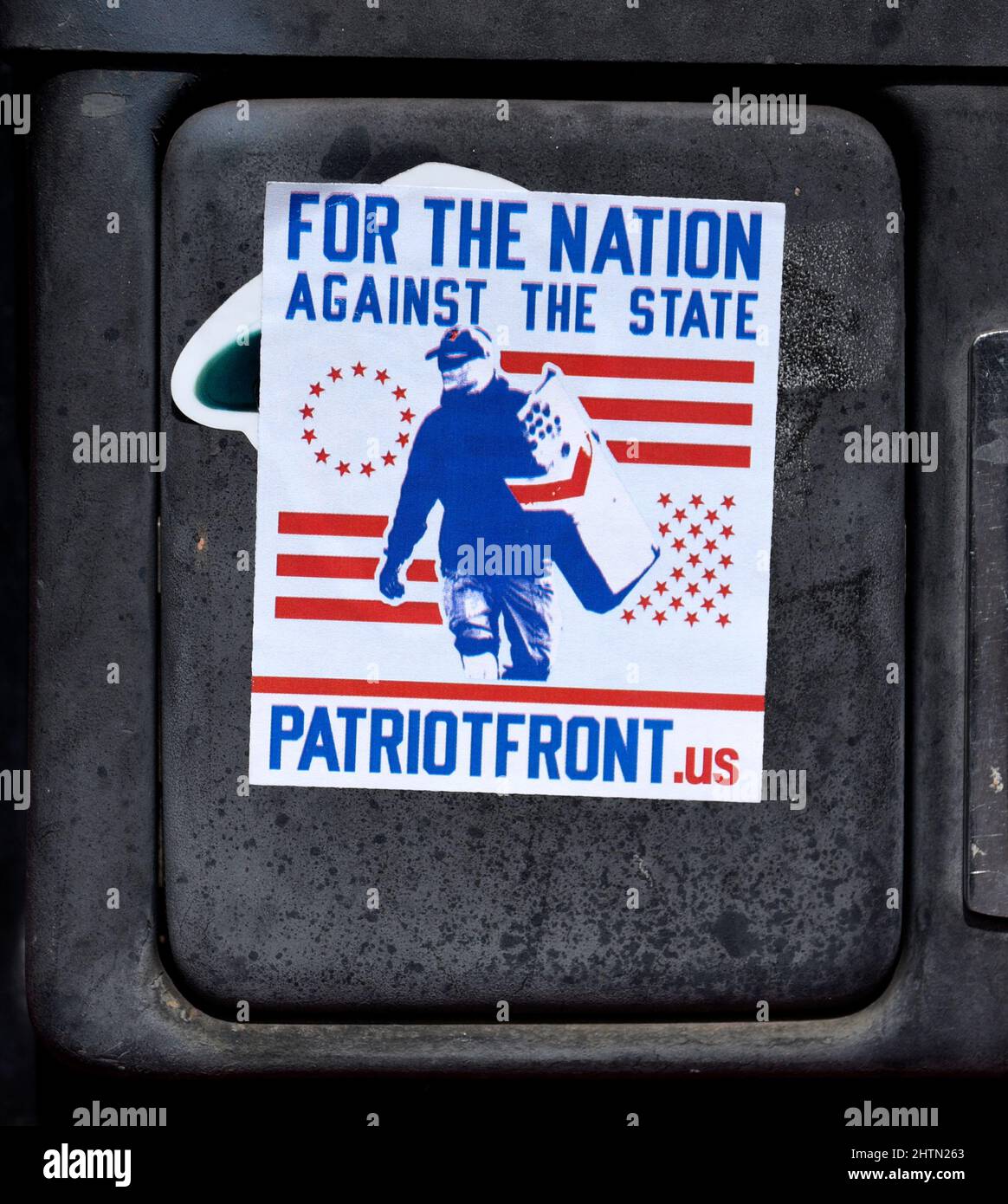 A Patriot Front decal placed on a pay phone by a supporter of the Alt-right, neo-Nazi, white supremacist, American nationalist organization. Stock Photo