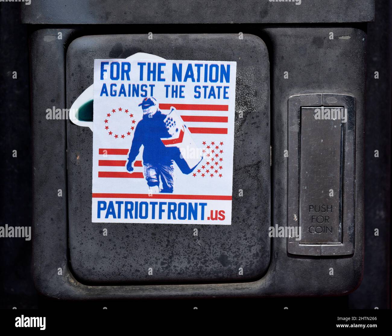 A Patriot Front decal placed on a pay phone by a supporter of the Alt-right, neo-Nazi, white supremacist, American nationalist organization. Stock Photo