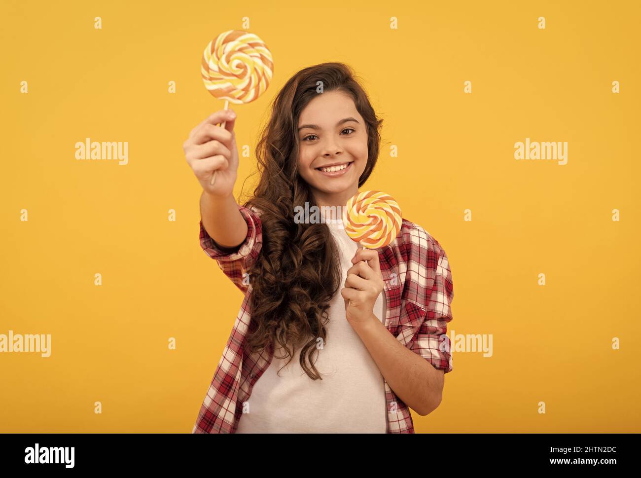 sweet childhood life. teen dental care. sweet tooth. yummy. happy girl hold lollipop. lollipop child Stock Photo