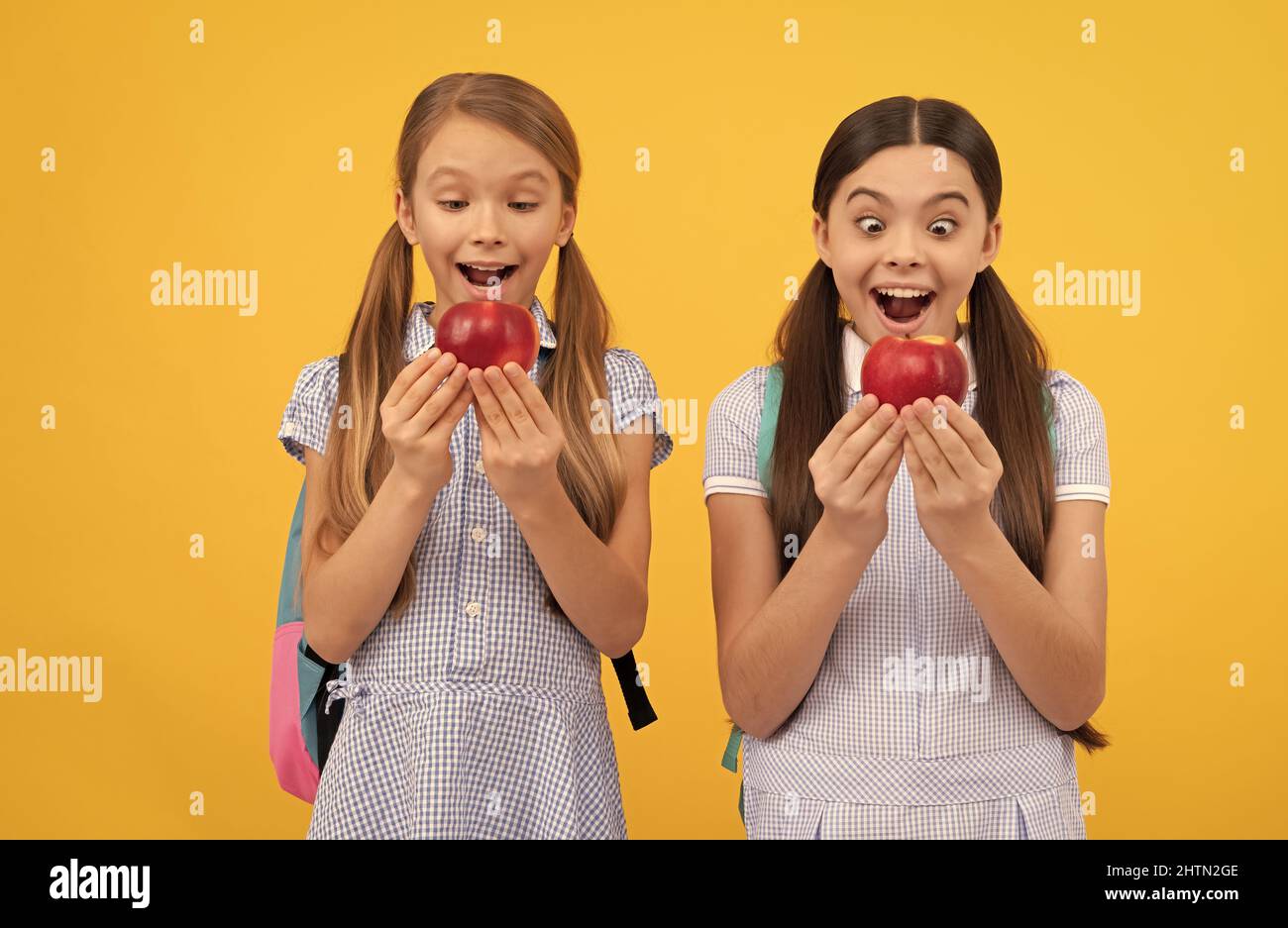 Nutrition for kids. Surprised children hold apples. School nutrition. Food education Stock Photo