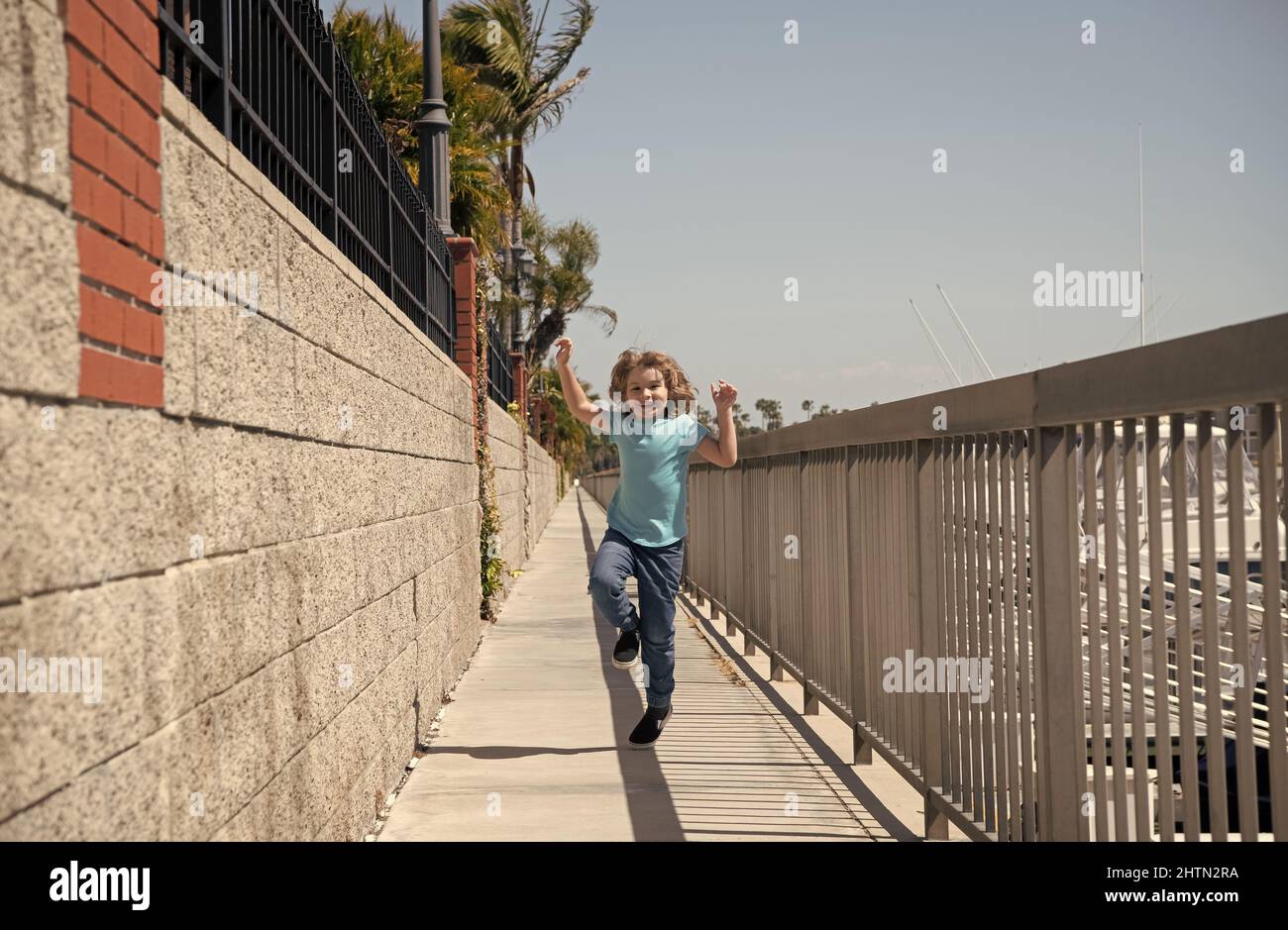 Break free. Energetic child run on promenade. Happy boy enjoy free time. Having fun. Summer vacation Stock Photo
