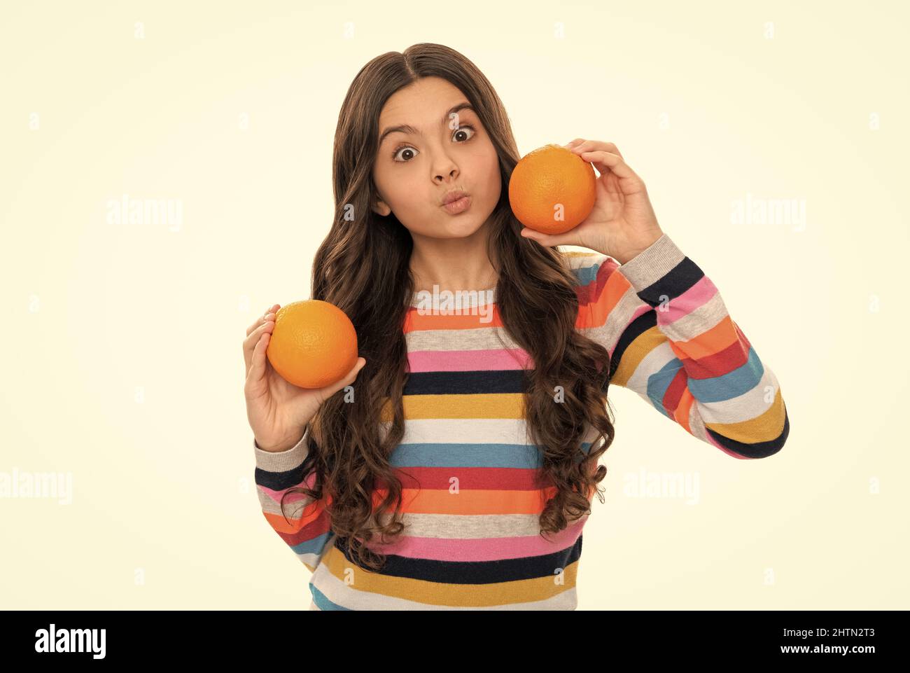 funny child eating healthy food. childhood health. citrus fruits. natural organic fresh orange. Stock Photo