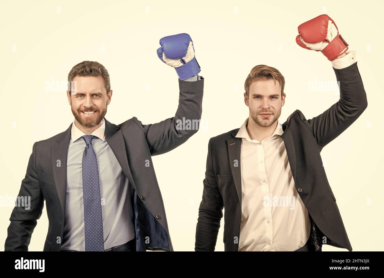 two successful business men in boxing gloves raised hands isolated on white, teamwork success Stock Photo