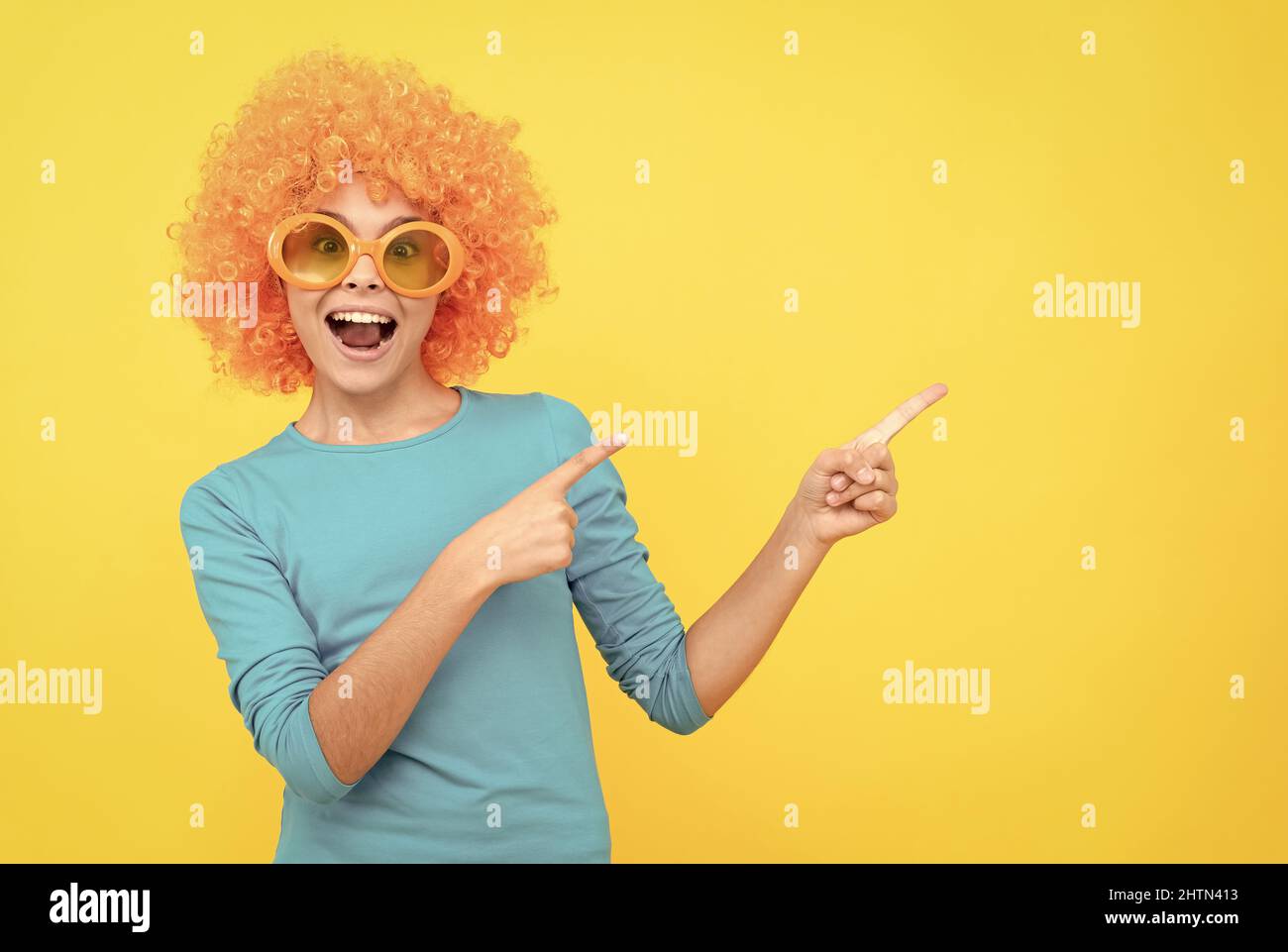 Cheerful teen girl presenting hair hi-res stock photography and images ...