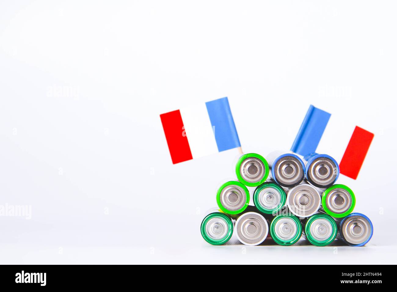 Battery. A lot of batteries on the background of the flag of france. Alkaline and alkaline battery. Zinc and salt battery. Lithium import. Waste dispo Stock Photo