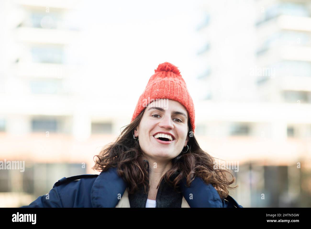 Portrait of smiling woman in knit hat outdoors Stock Photo