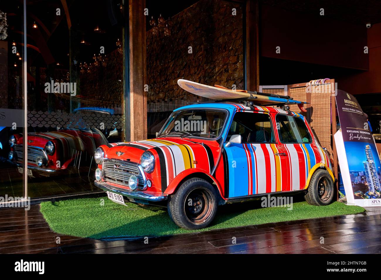 Paul Smith striped Mini car painted with multicolored stripes with roof  mounted surfboard. Fun car for young outdoor owner Stock Photo - Alamy