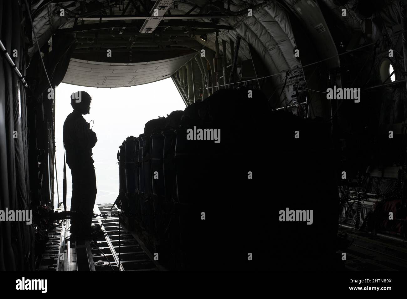 Staff Sgt. McArthur Posey, 36th Expeditionary Airlift Squadron loadmaster, prepares containerized delivery systems (CDS) for air drop on a C-130J Super Hercules as during Exercise Cope South 2022, Feb. 20, 2022, over Bangladesh. Airmen assigned to the 36th EAS worked side-by-side with Bangladesh air force (BAF) pilots and maintainers to perform air drops and low level flying as part of the day’s tasks. Exercise Cope South provides an opportunity for Pacific Air Forces and the Bangladesh armed forces to strengthen their relationship and enhance interoperability, to operate more effectively toge Stock Photo