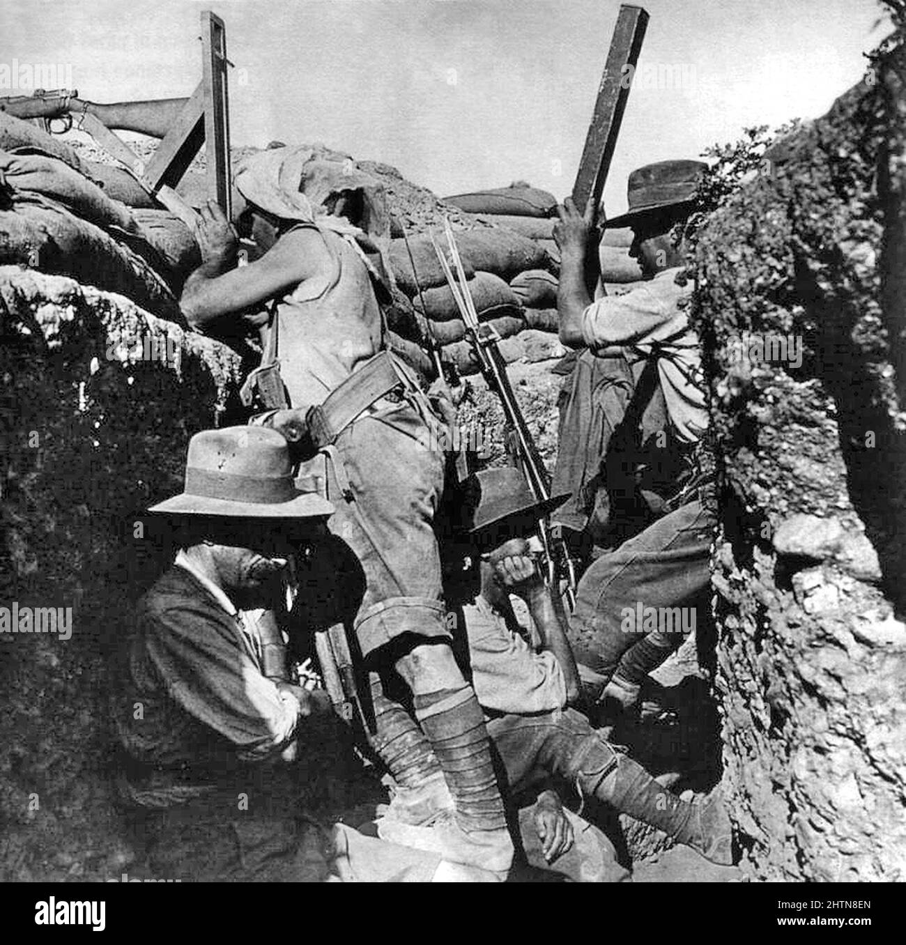 Australian light horseman using a periscope rifle to look over the top of a trench Stock Photo