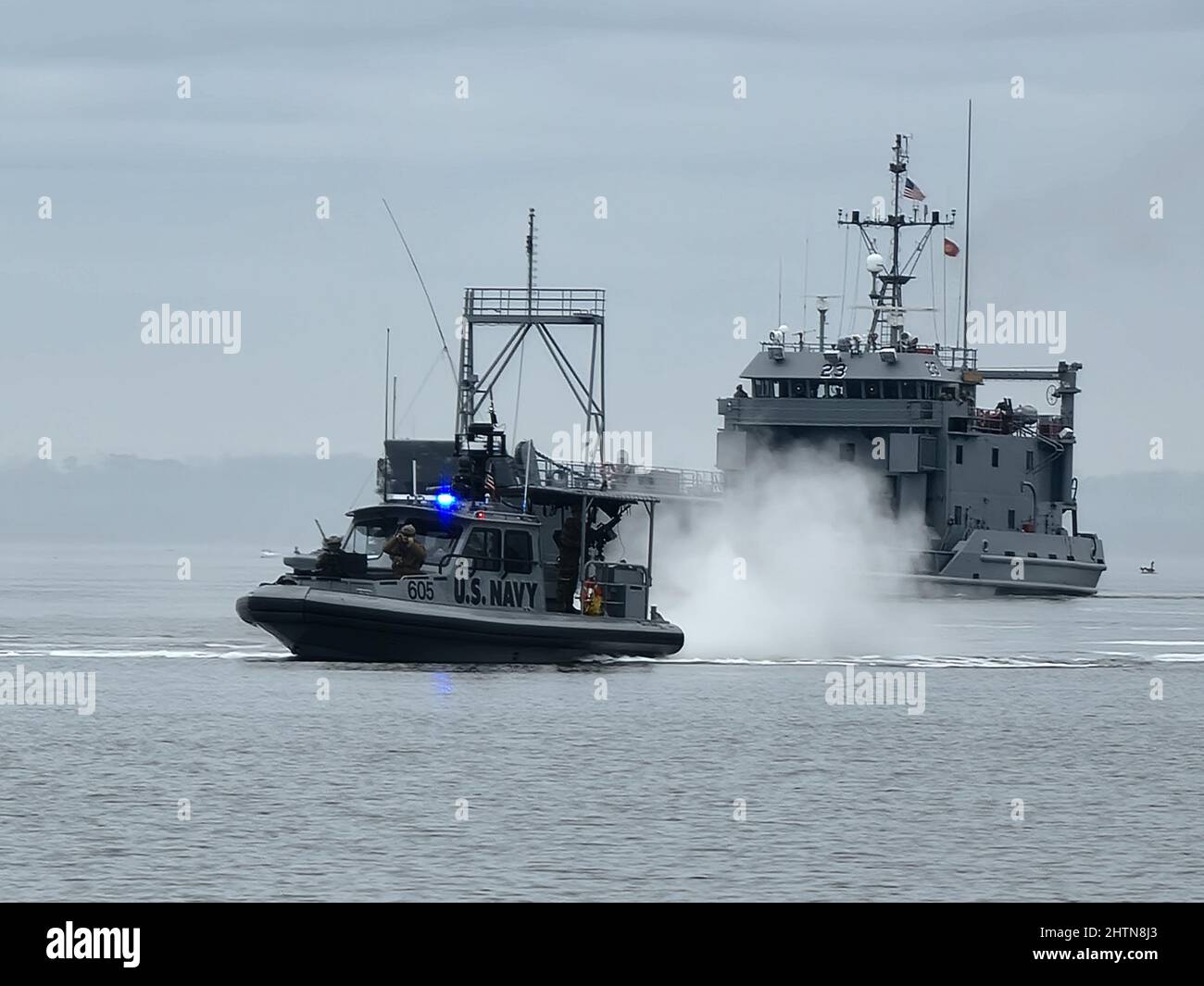 Fort Eustis, Virginia (February 03, 2022) Sailors assigned to Maritime Expeditionary Security Squadron TWO (MSRON 2) conduct a High Value Asset escort of US Army Runnymede-class large landing craft USAV HOBKIRK (LCU 2023) of the 329th Composite Watercraft Company (CWC) during MSRON 2’s Final Evaluation Problem (FEP).  The ability to protect vessels transiting choke points or entering and departing ports is essential to MSRON 2’s ability to support the fleet and joint force in conducting maritime and combat operations.   (U.S. Navy photo by Boatswain’s Mate 1st Class Marc Elevado) Stock Photo