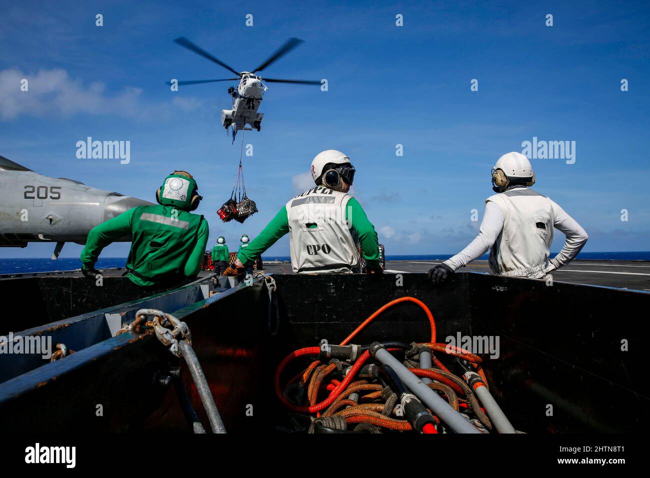 PHILIPPINE SEA (March 1, 2022) Sailors observe an AS332 Super Puma ...