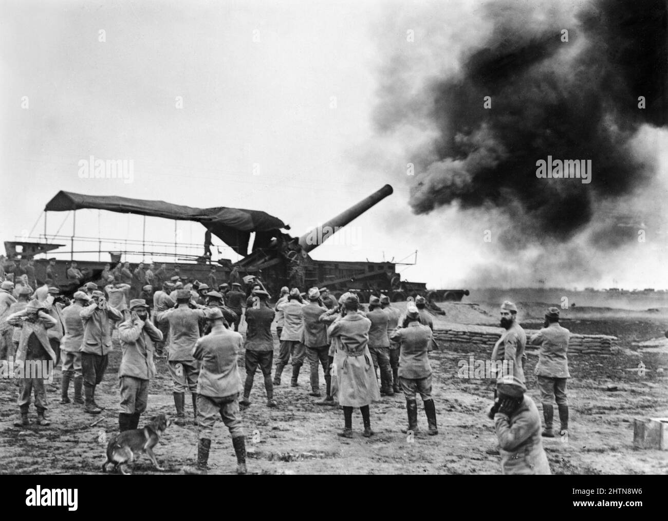 he Battle of the Somme, July-november 1916 12 inch Mark IX gun of the Royal Garrison Artillery (on a railway mounting) firing a shot near Meaulte, August 1916. In the foreground, a group of watching French soldiers cover their ears against the blast. Stock Photo
