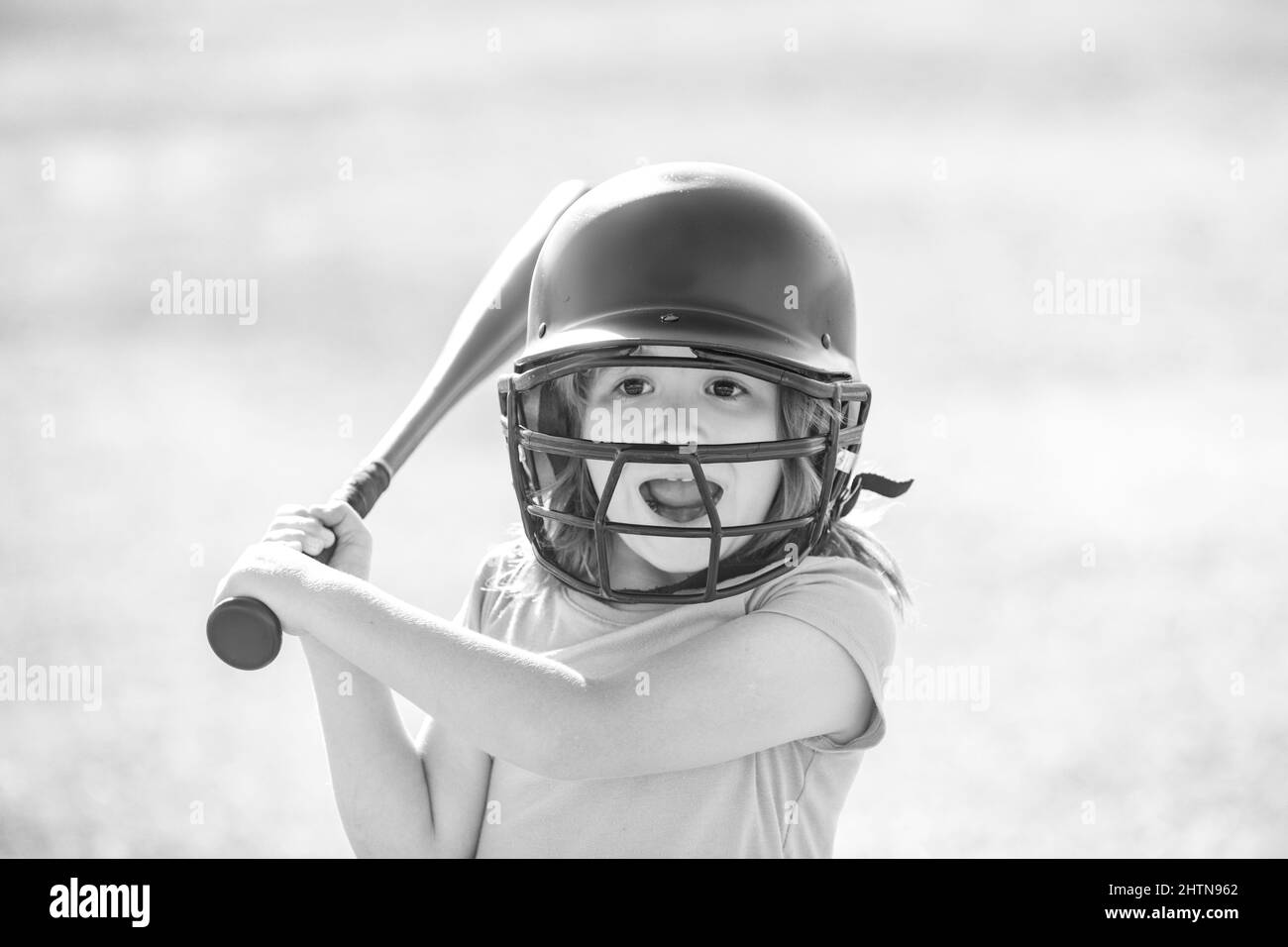 Excited kid holding a baseball bat. Pitcher child about to throw in