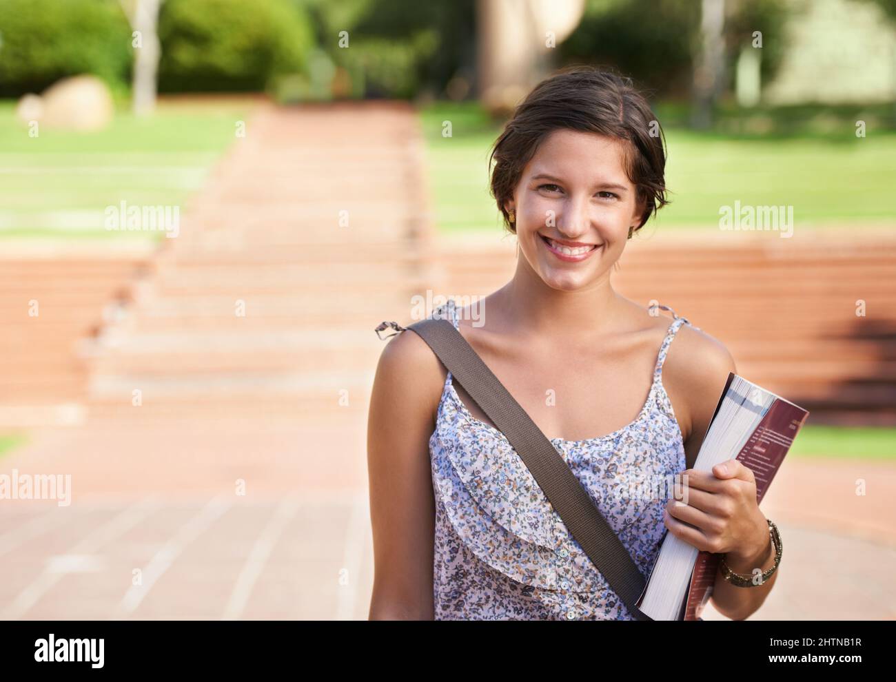 Preparing for a bright future. A beautiful young student standing on campus smiling at the camera. Stock Photo