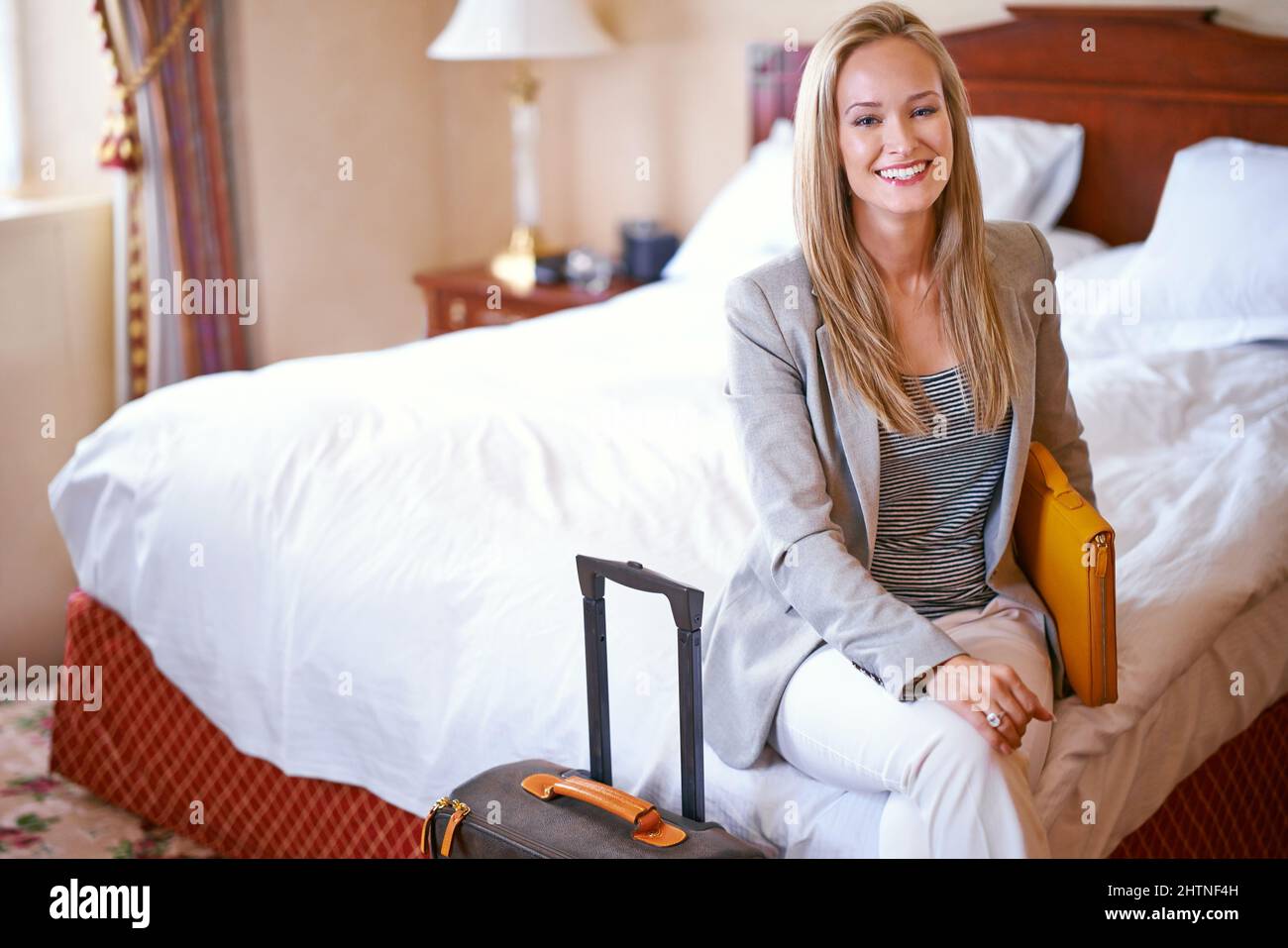 The only suite I check into when i travel for business. Portrait of a beautiful businesswoman in her hotel room. Stock Photo