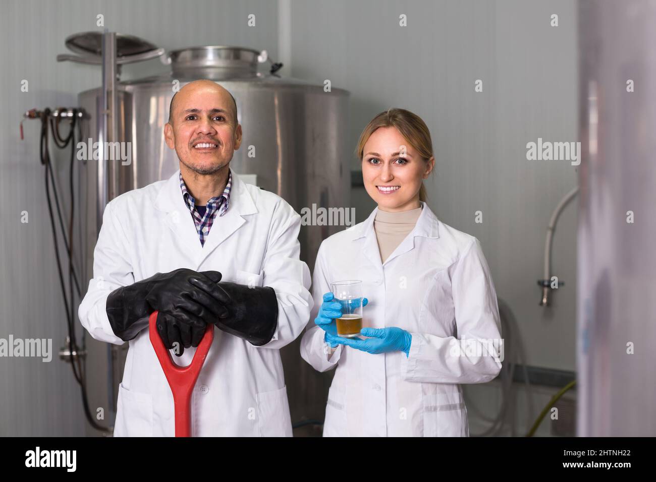 Two brewery workers on beer factory. Stock Photo