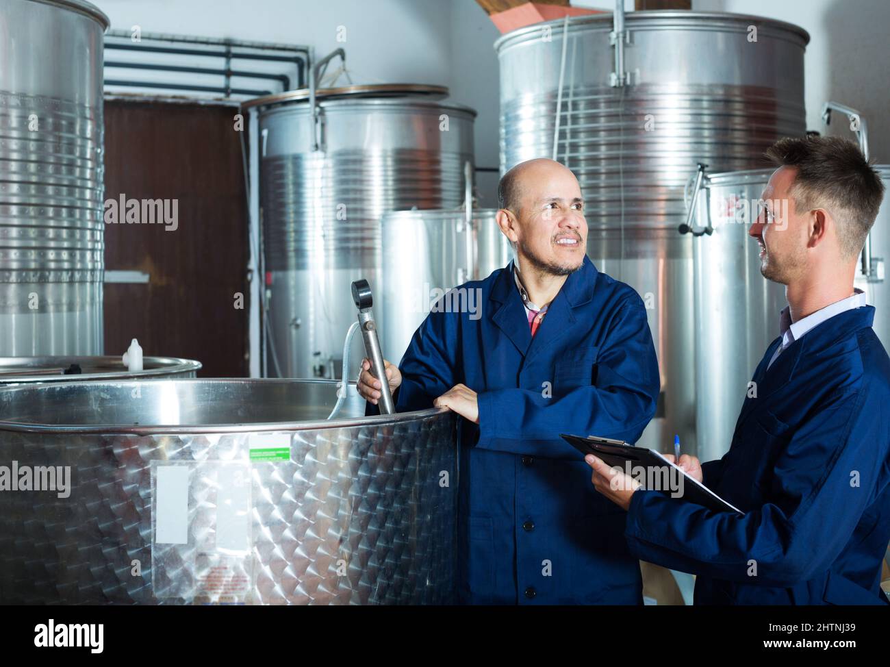 Worker taking notes in fermentation section Stock Photo