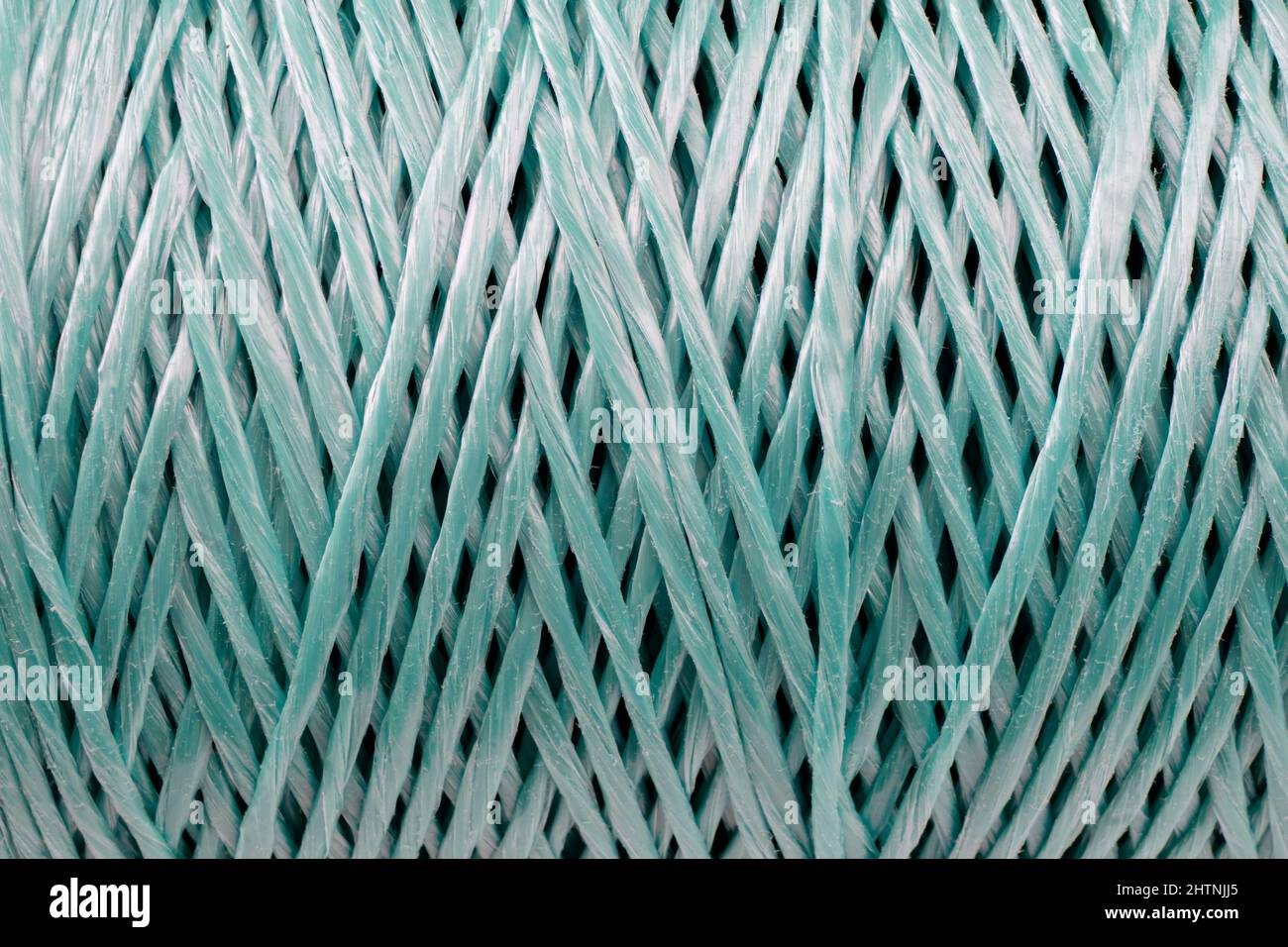 Coiled nylon rope texture background. Blue rolled  striped nylon rope pattern. A coil of new colored rope surface Stock Photo