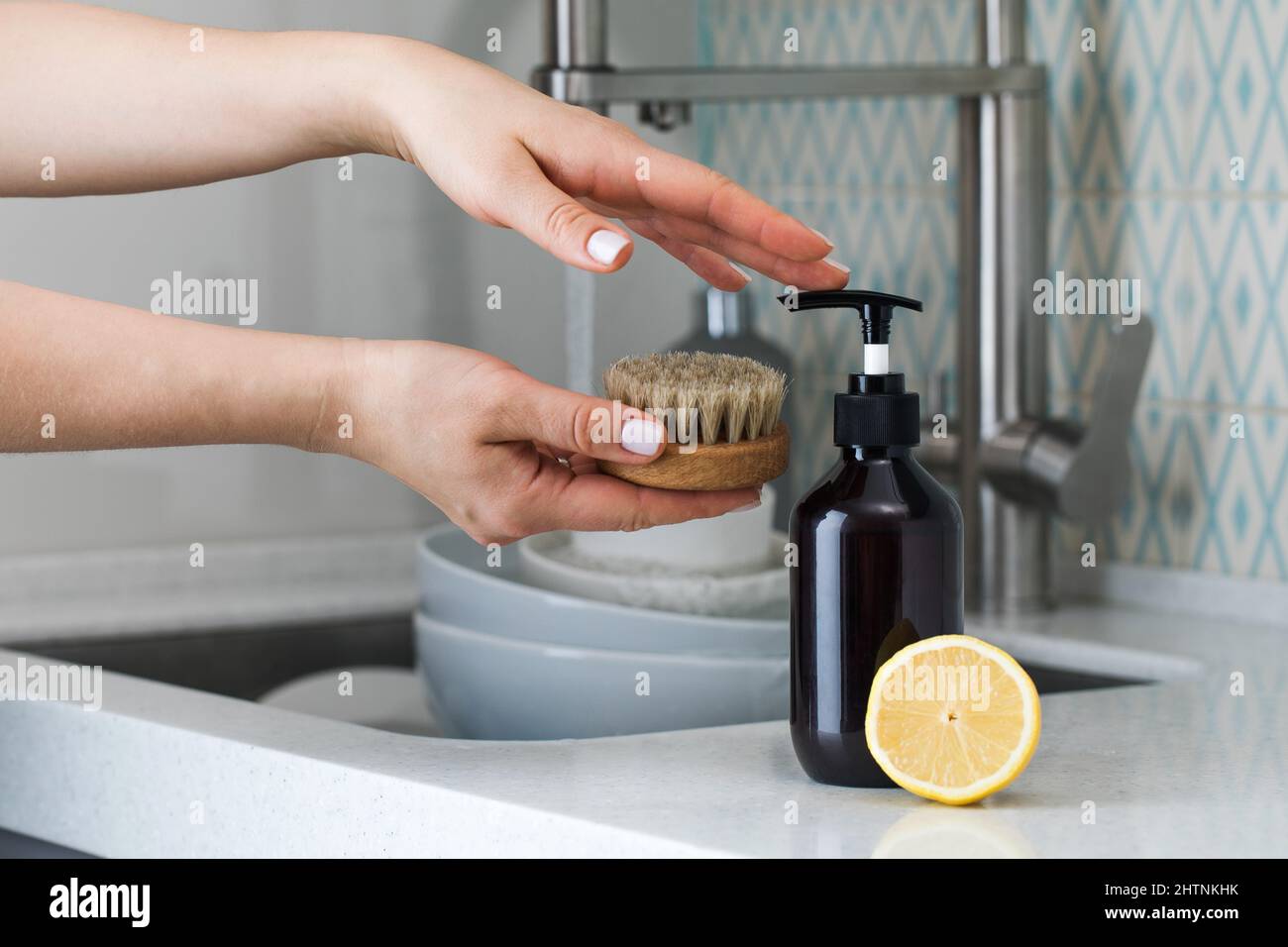 A housewife clicks on a dispenser with an environmentally friendly