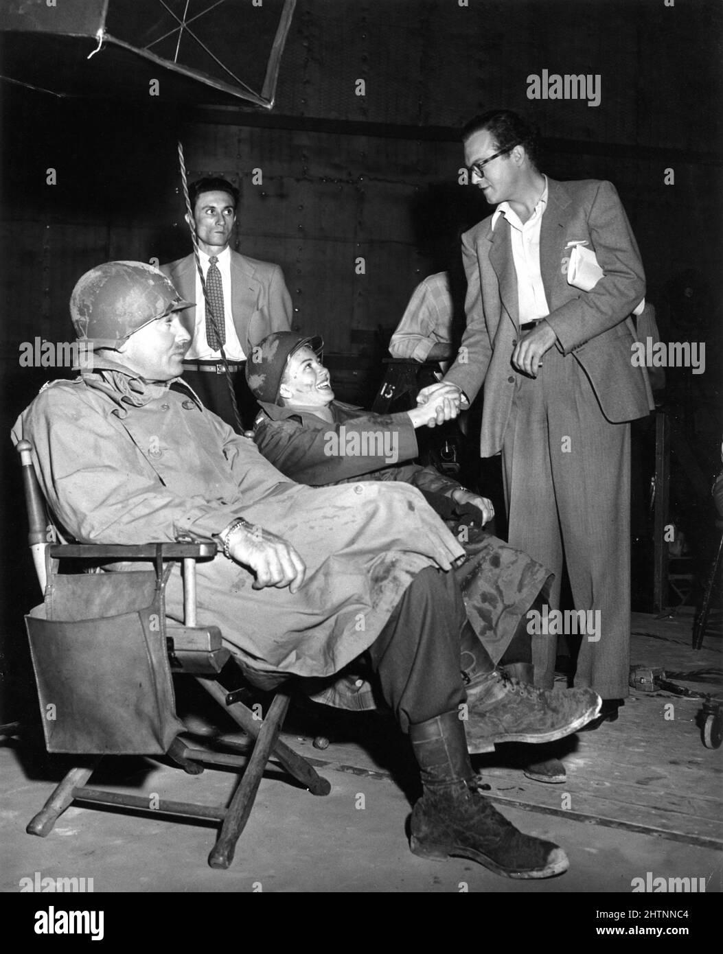CLARK GABLE and LANA TURNER with Set Visitor VAN HEFLIN during a break in  filming of