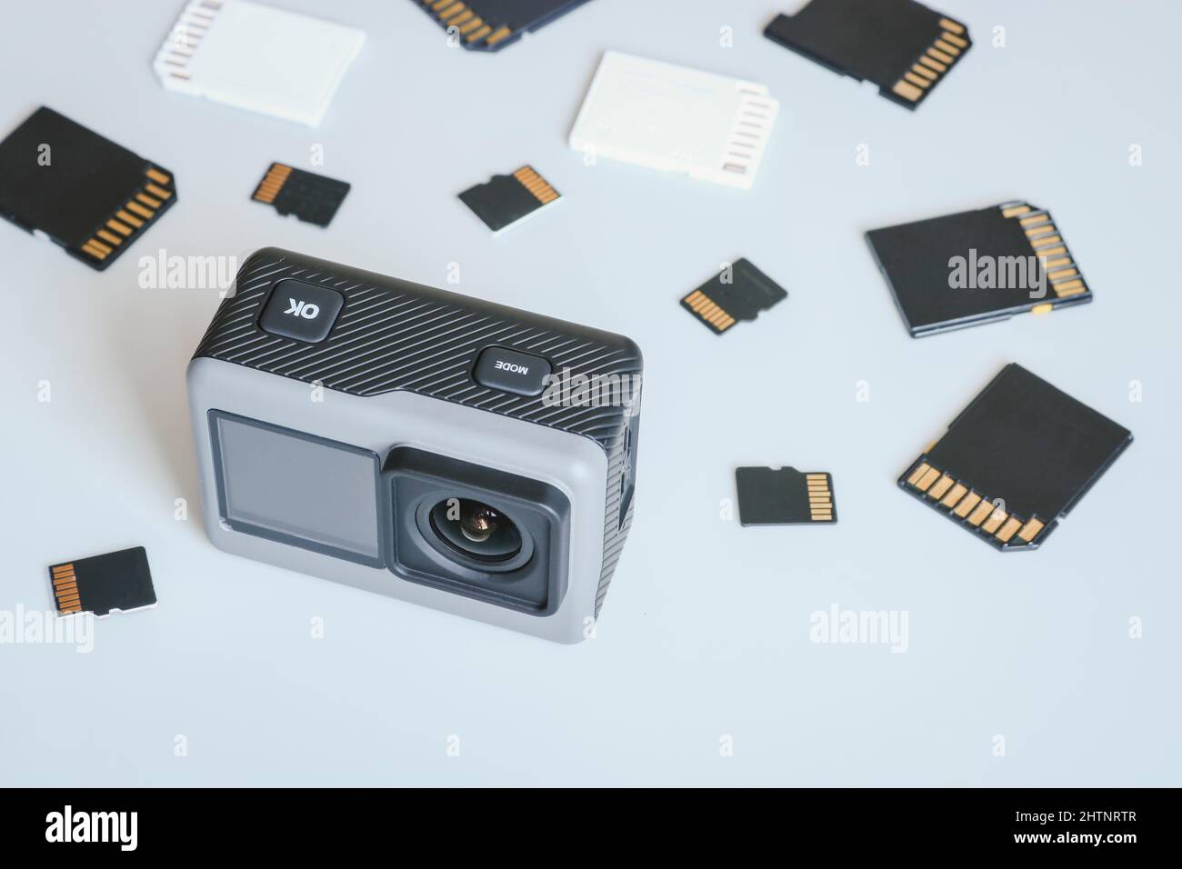 Action camera and SD and MicroSD memory cards. Background from gadgets and digital devices. Stock Photo