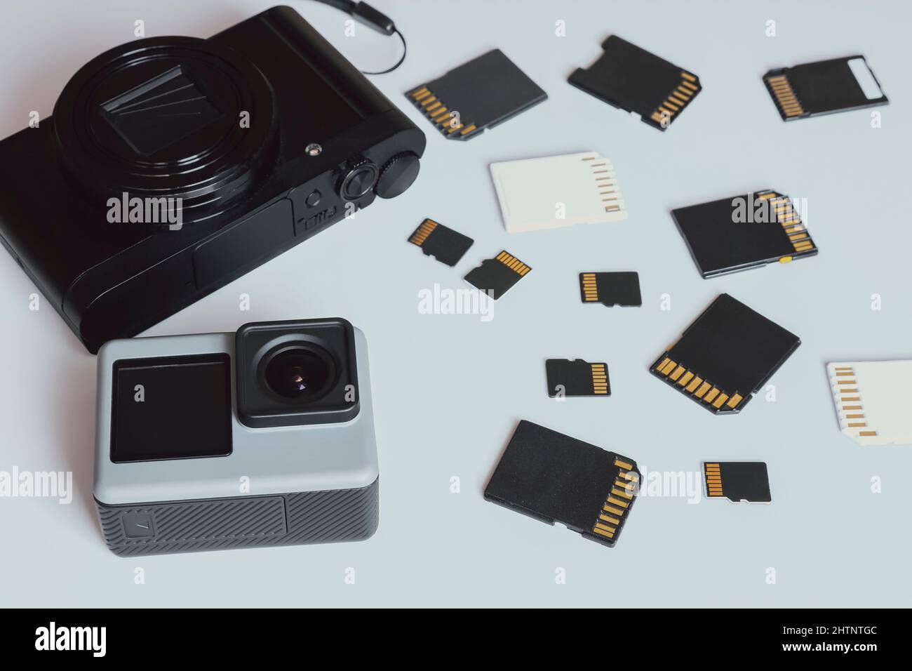 Action camera, digital camera and SD and MicroSD memory cards. Background from gadgets and digital devices. Stock Photo
