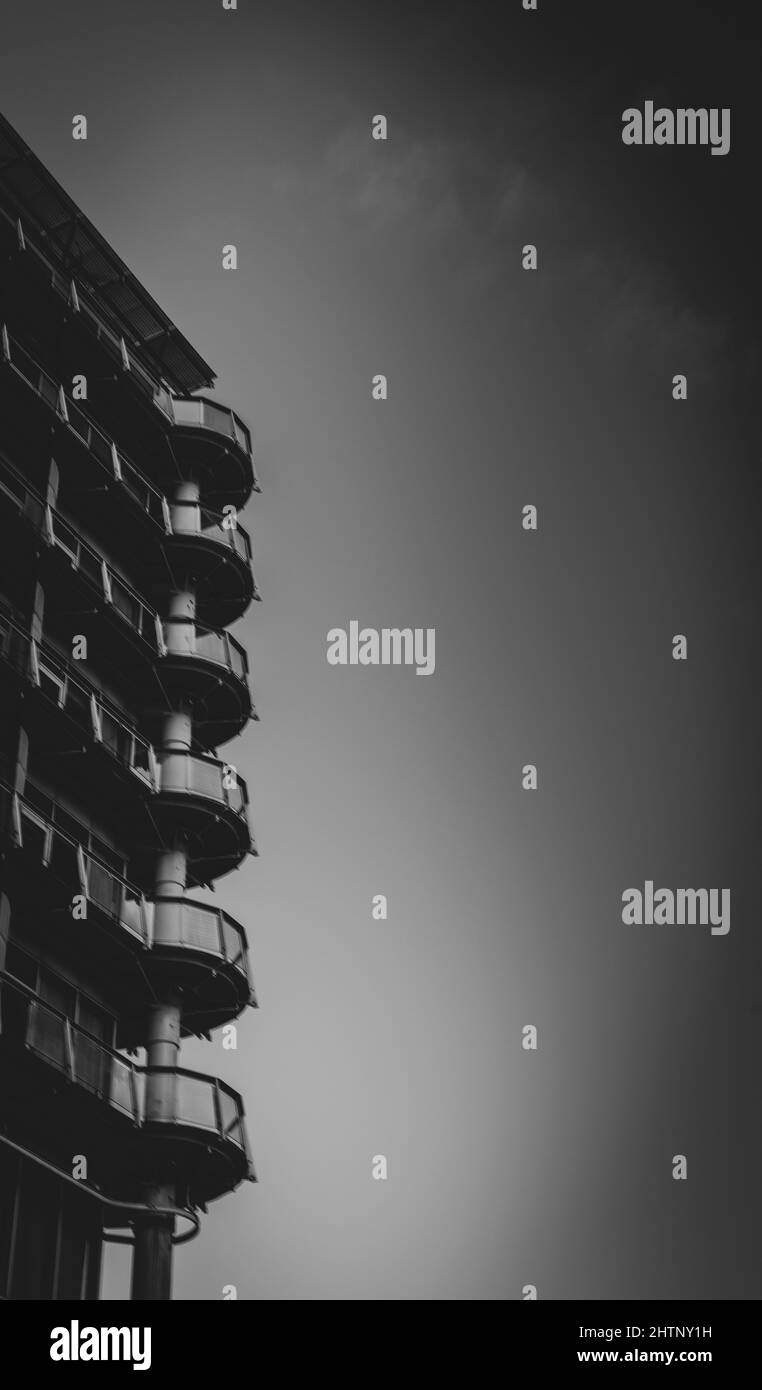 Vertical grayscale shot of a building with balconies Stock Photo - Alamy