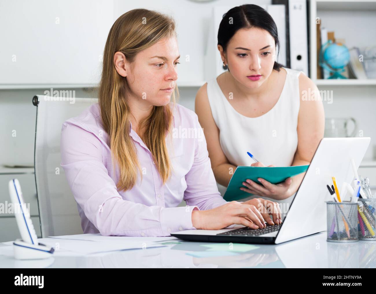 Manager inspecting work Stock Photo - Alamy