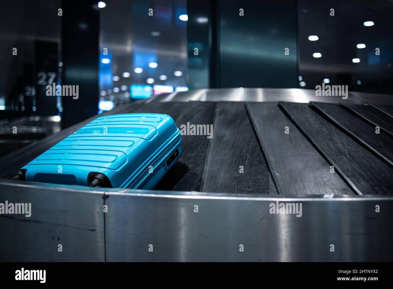 Arrived luggage going around on a conveyor belt waiting to be claimed