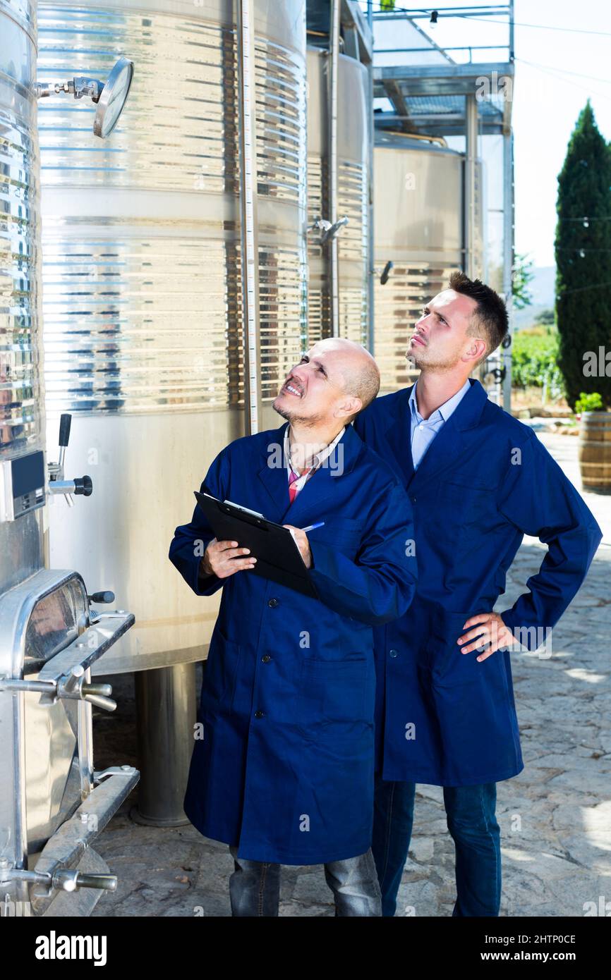 Worker taking notes in fermentation section Stock Photo