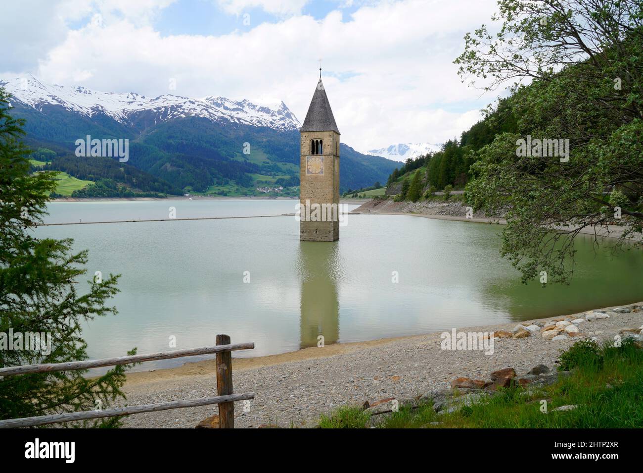 a picturesque view of lake Resia and the sunken church steeple of Lago di Resia in the Curon region (Vinschgau, South Tyrol, Italy) Stock Photo