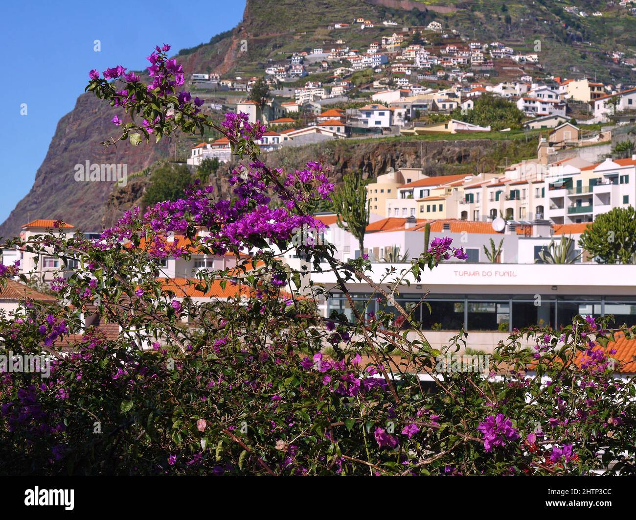 Hillside village near mountains Stock Photo - Alamy