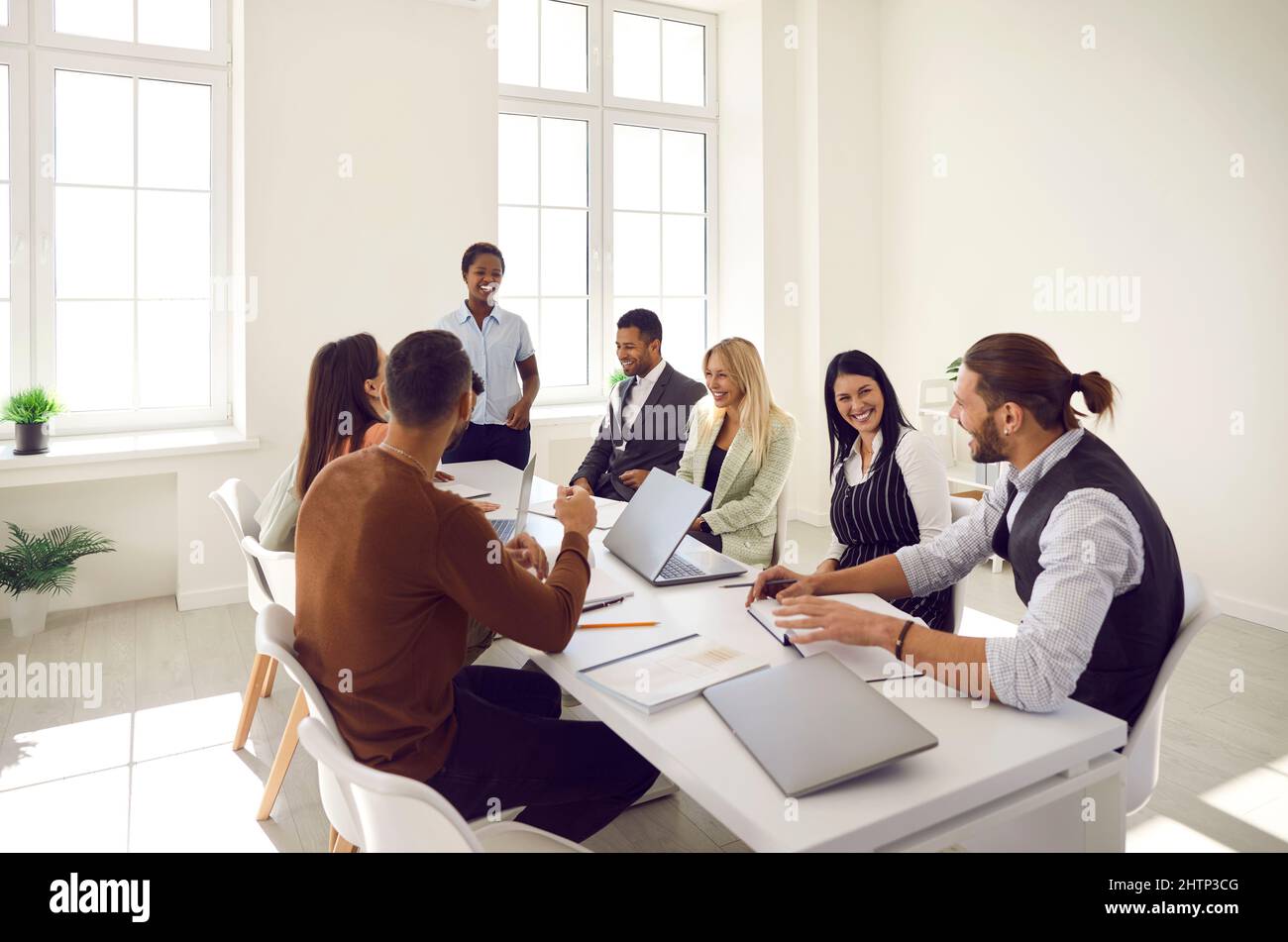 Diverse team of happy business people laughing at something during a work meeting Stock Photo