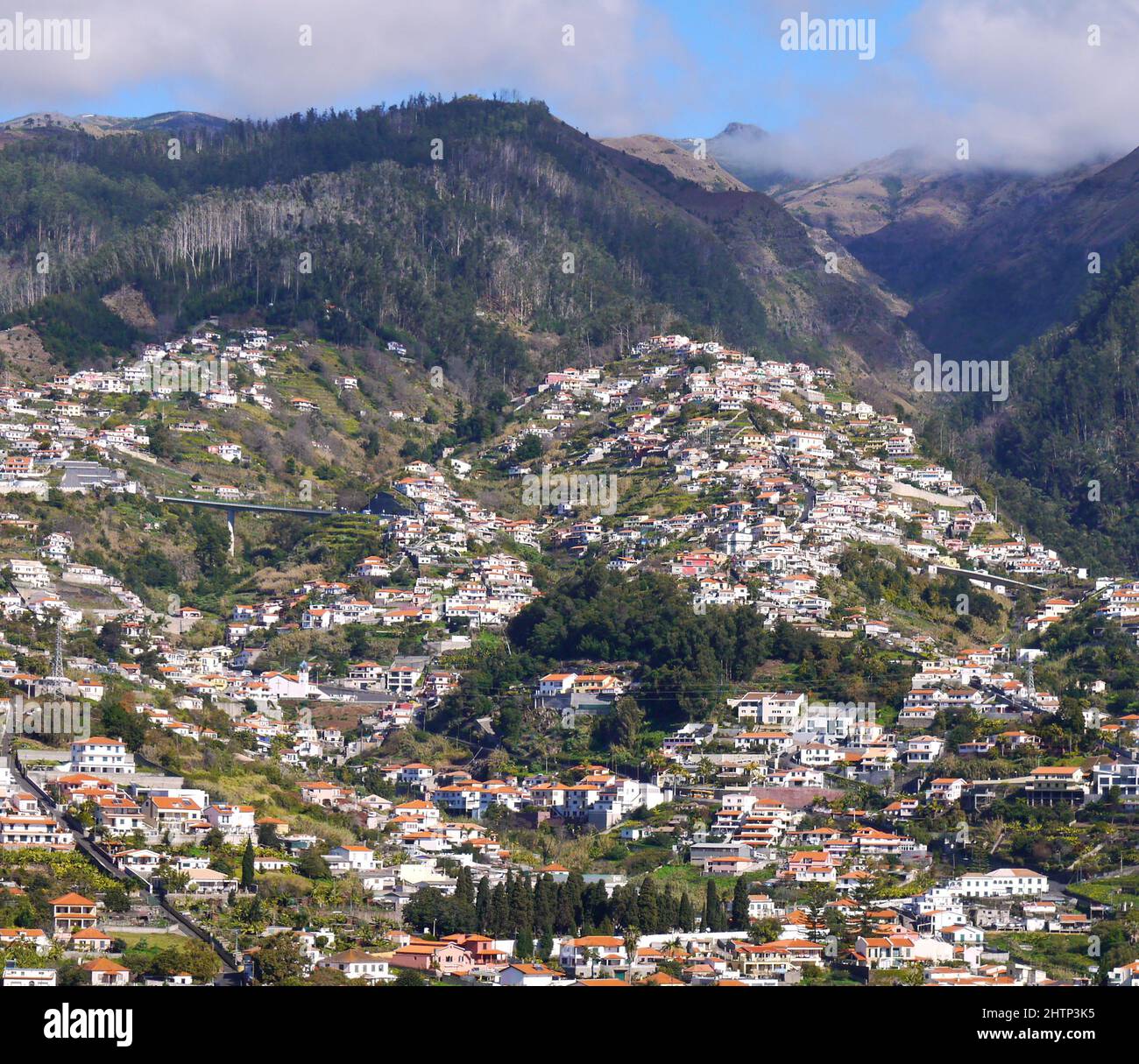 Hillside village near mountains Stock Photo - Alamy