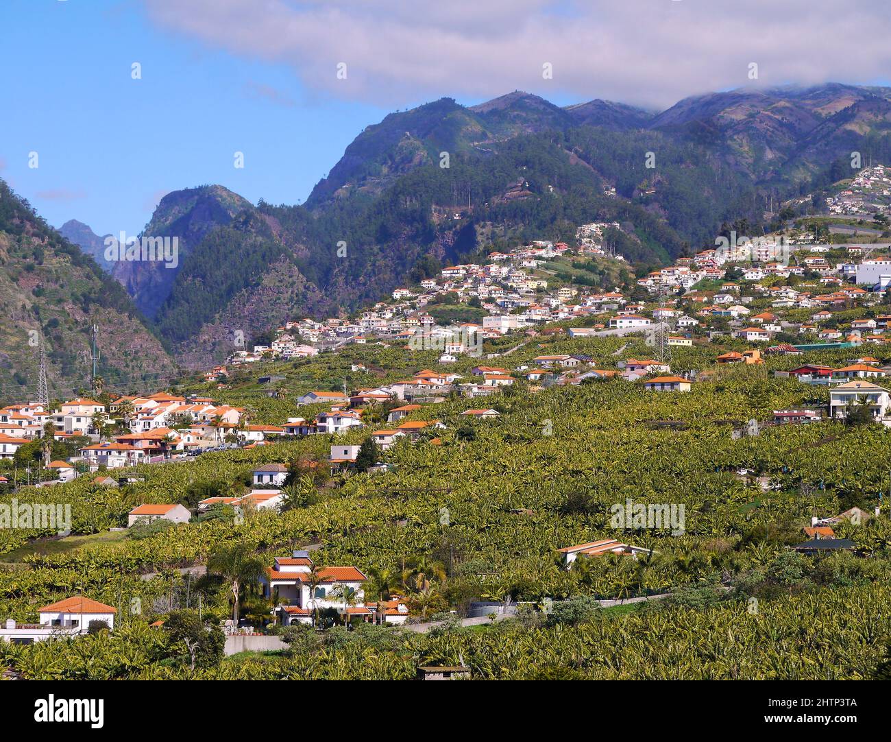 Hillside village near mountains Stock Photo - Alamy
