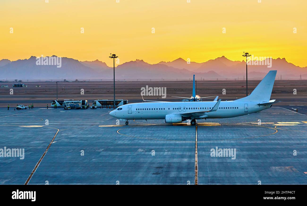 passenger planes parked at the airport at sunset Stock Photo - Alamy
