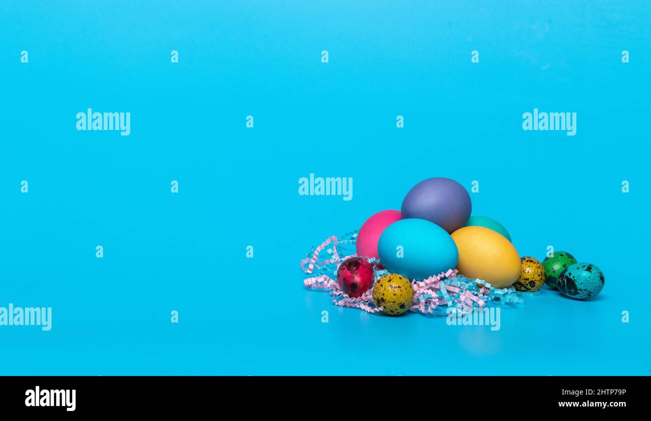 multi-colored easter eggs on a blue background Stock Photo
